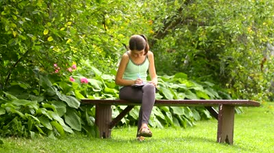stock-footage-girl-writing-in-the-garden